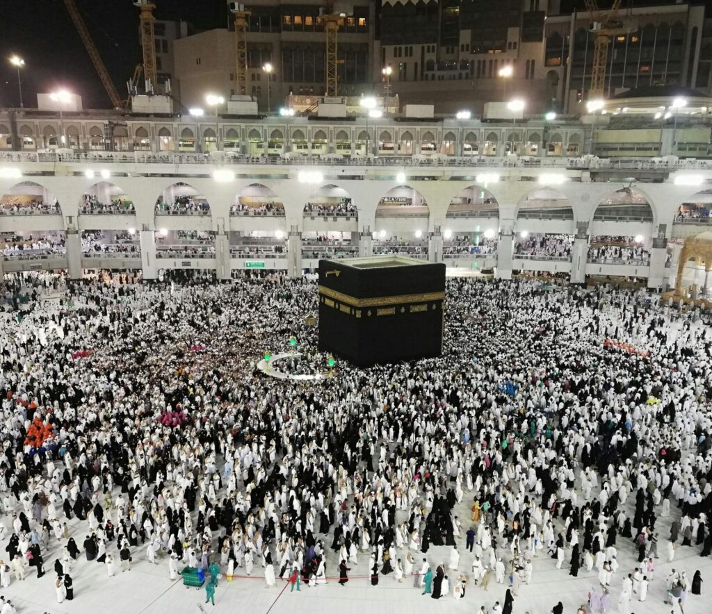 From above of crowded square around Kaaba cube in Great Mosque of Mecca at night time